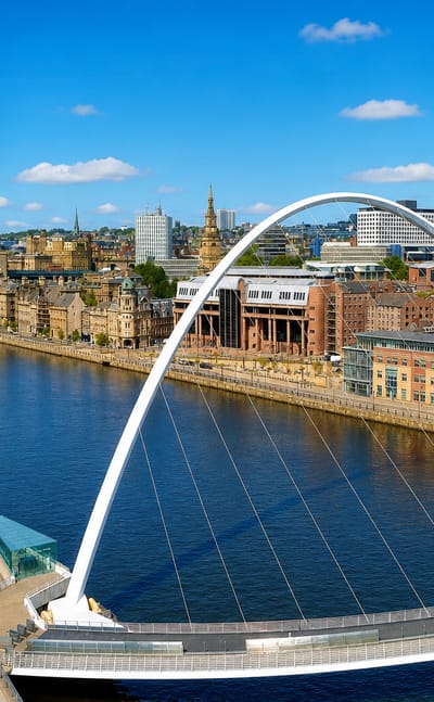 The Gateshead Millennium and Tyne bridges arching over the River Tyne along Newcastle upon Tyne's quayside.