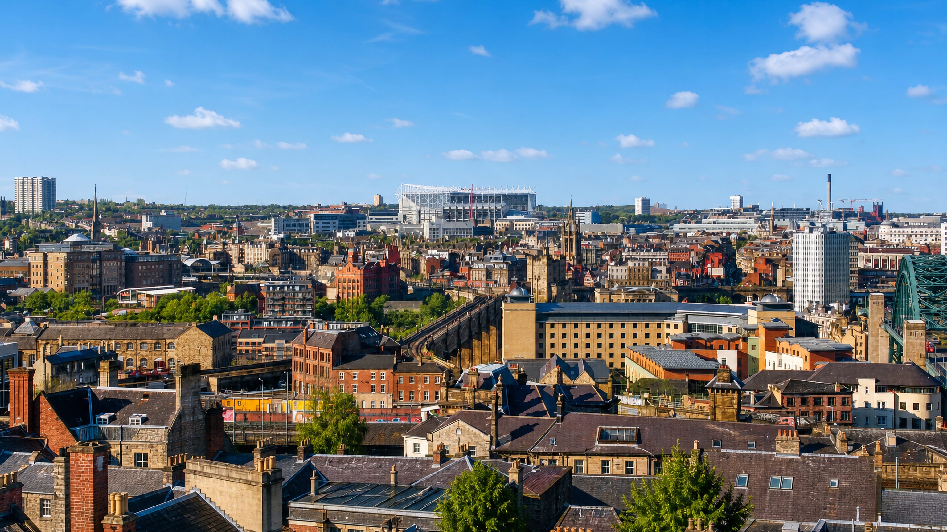 Rooftop view across Newcastle city centre with St James' Park stadium on the skyline
