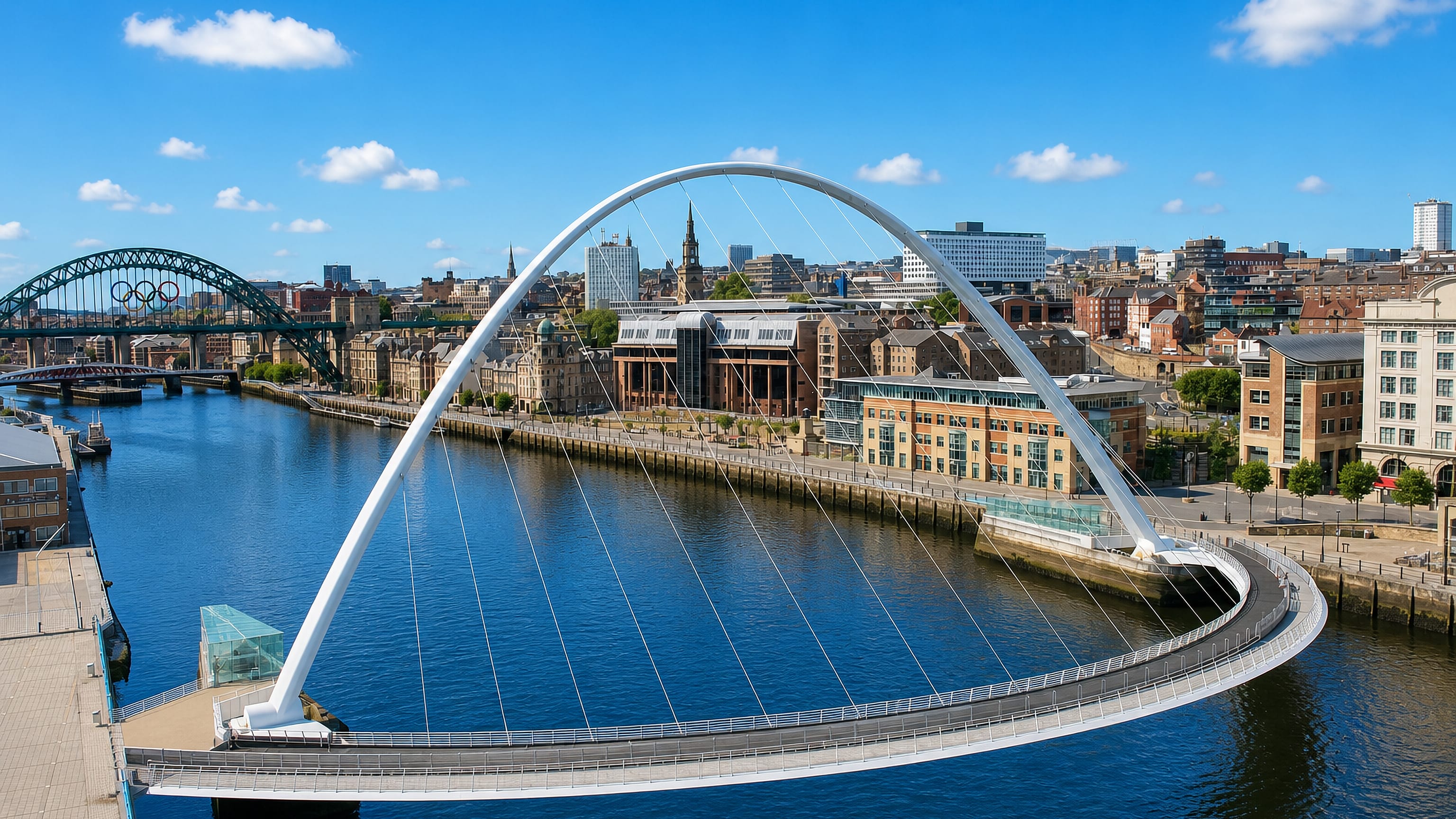 Gateshead Millennium Bridge arching over the Tyne with the Tyne Bridge and Newcastle Quayside behind