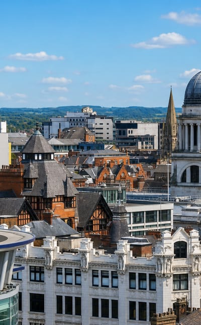 Nottingham's city centre with the domed Council House rising above red-brick rooftops under a blue sky
