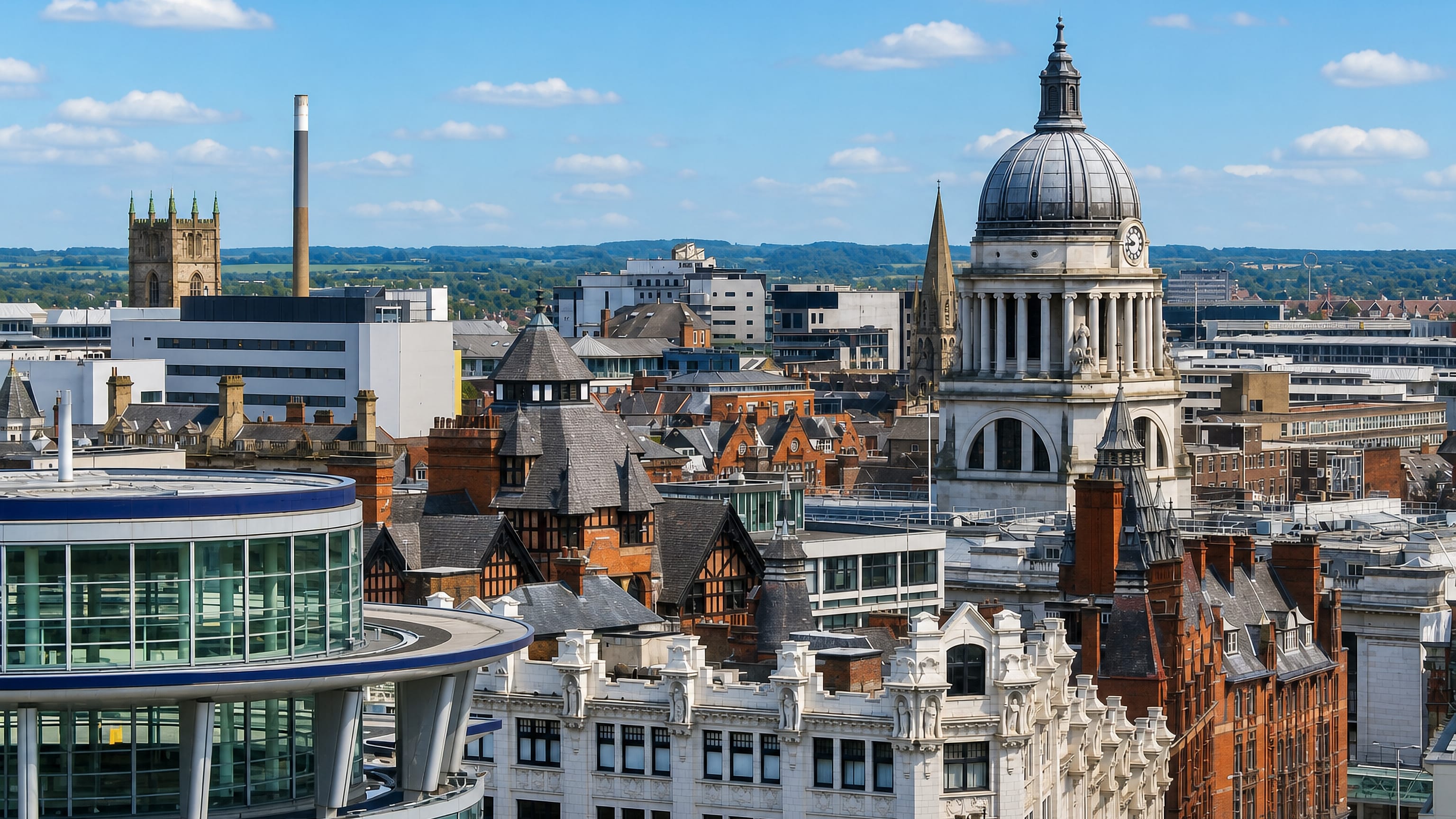 Nottingham's city centre with the domed Council House rising above red-brick rooftops under a blue sky