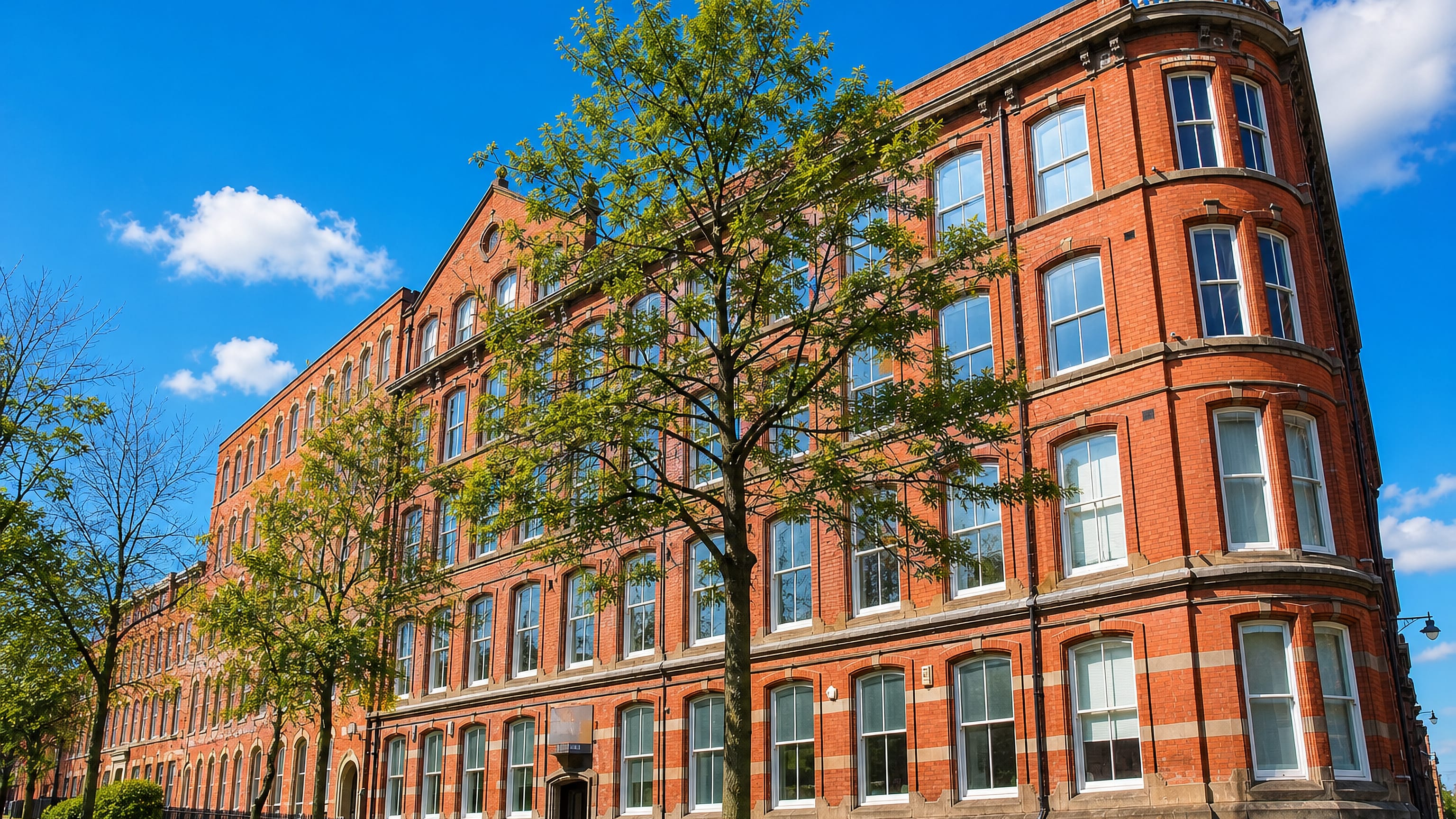 A red-brick Victorian lace warehouse with a rounded corner bay in Nottingham's Lace Market.