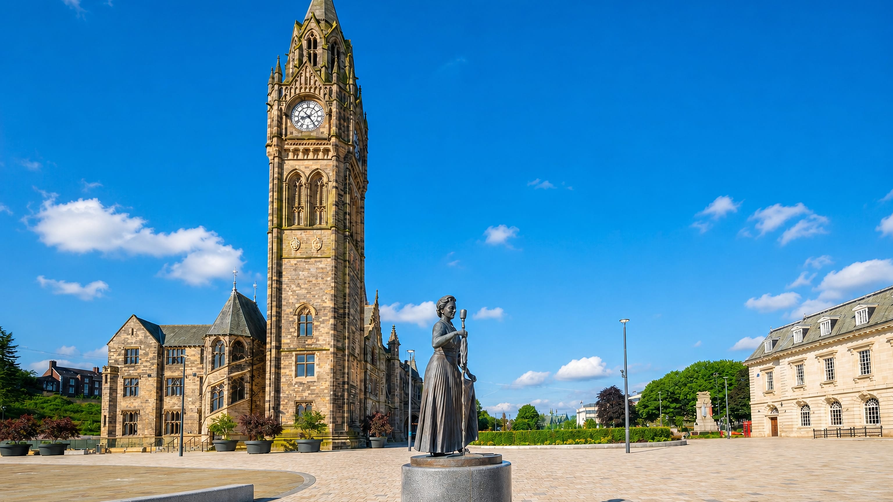 Rochdale Town Hall's Gothic clock tower rising over the paved town square in Rochdale, England.