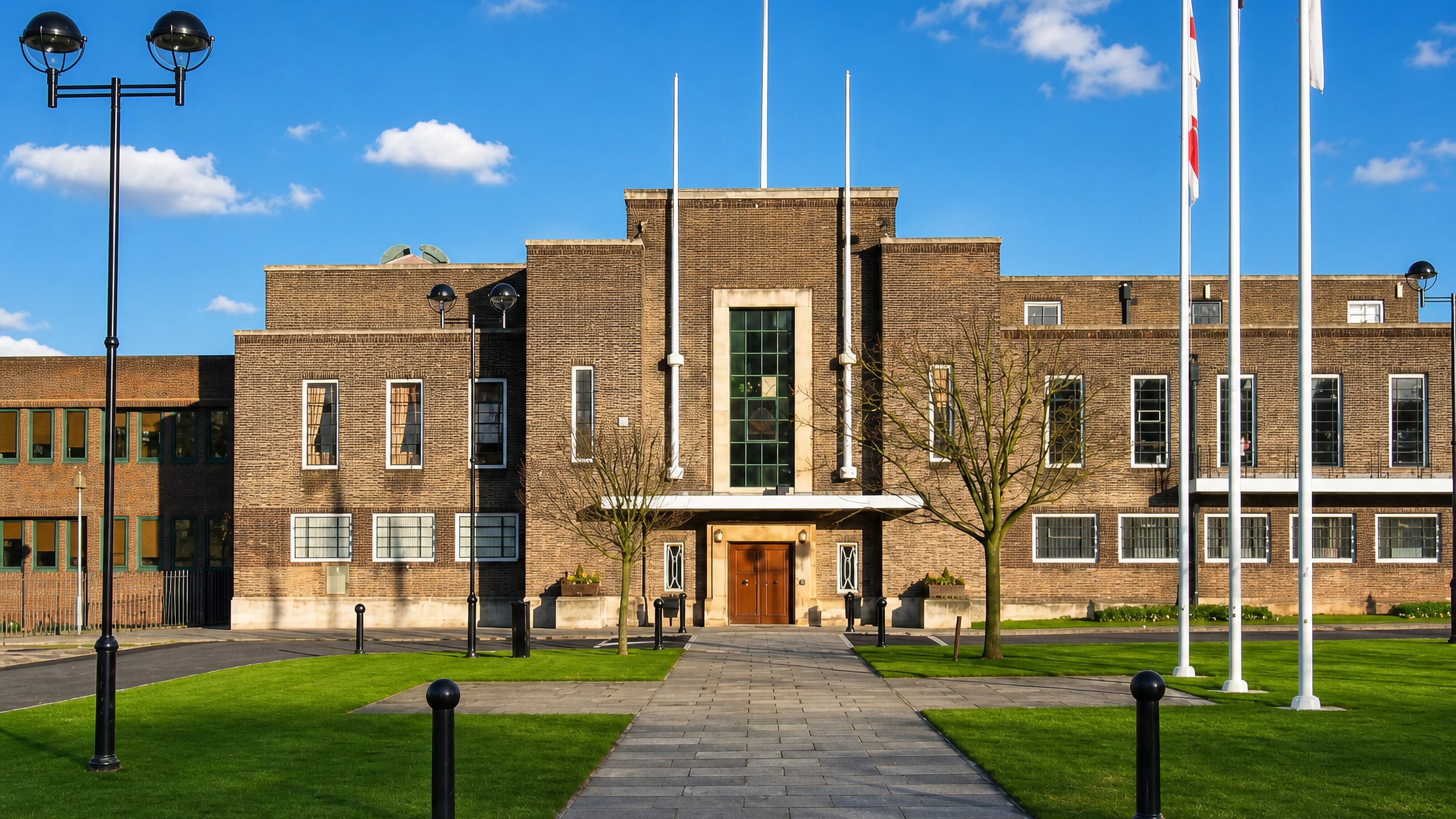 The 1930s brick town hall with flagpoles and lawns in Romford, east London.