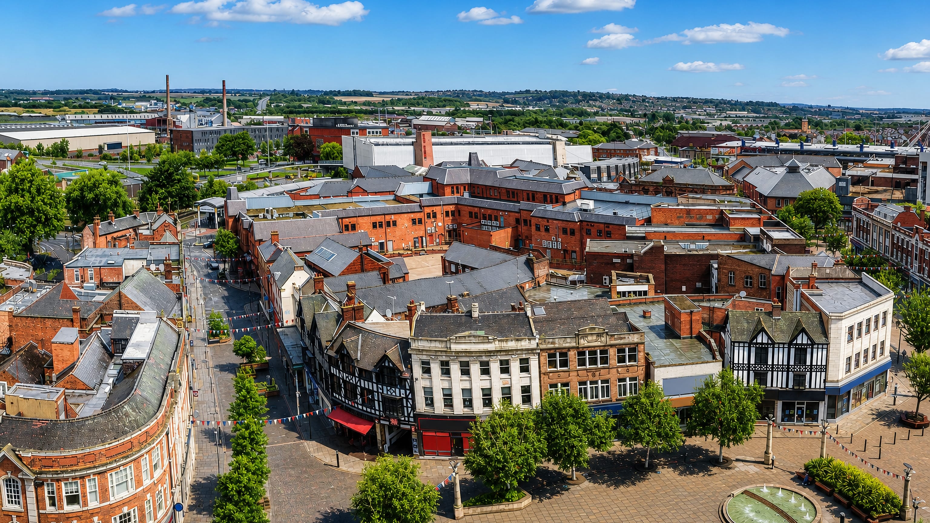 Aerial view of Rotherham town centre, with All Saints' Square fountains, red-brick shops and Tudor facades