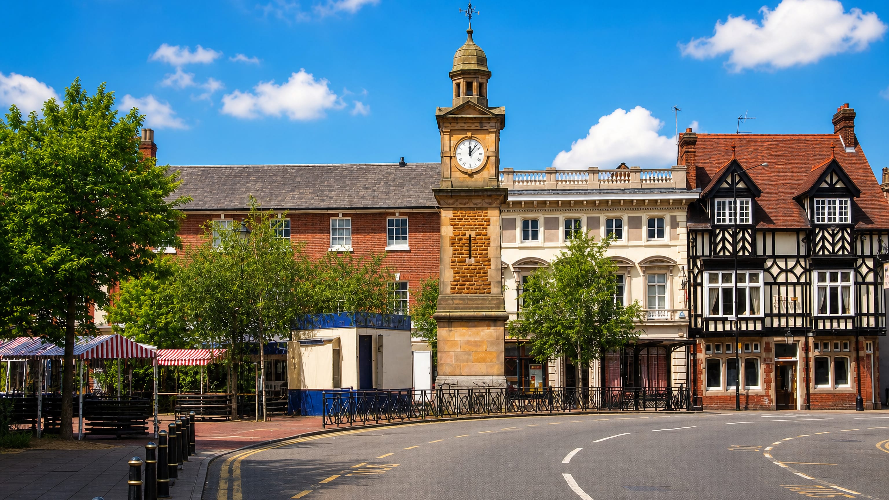 Sandstone clock tower and Tudor-style frontages around the Market Place in Rugby, Warwickshire