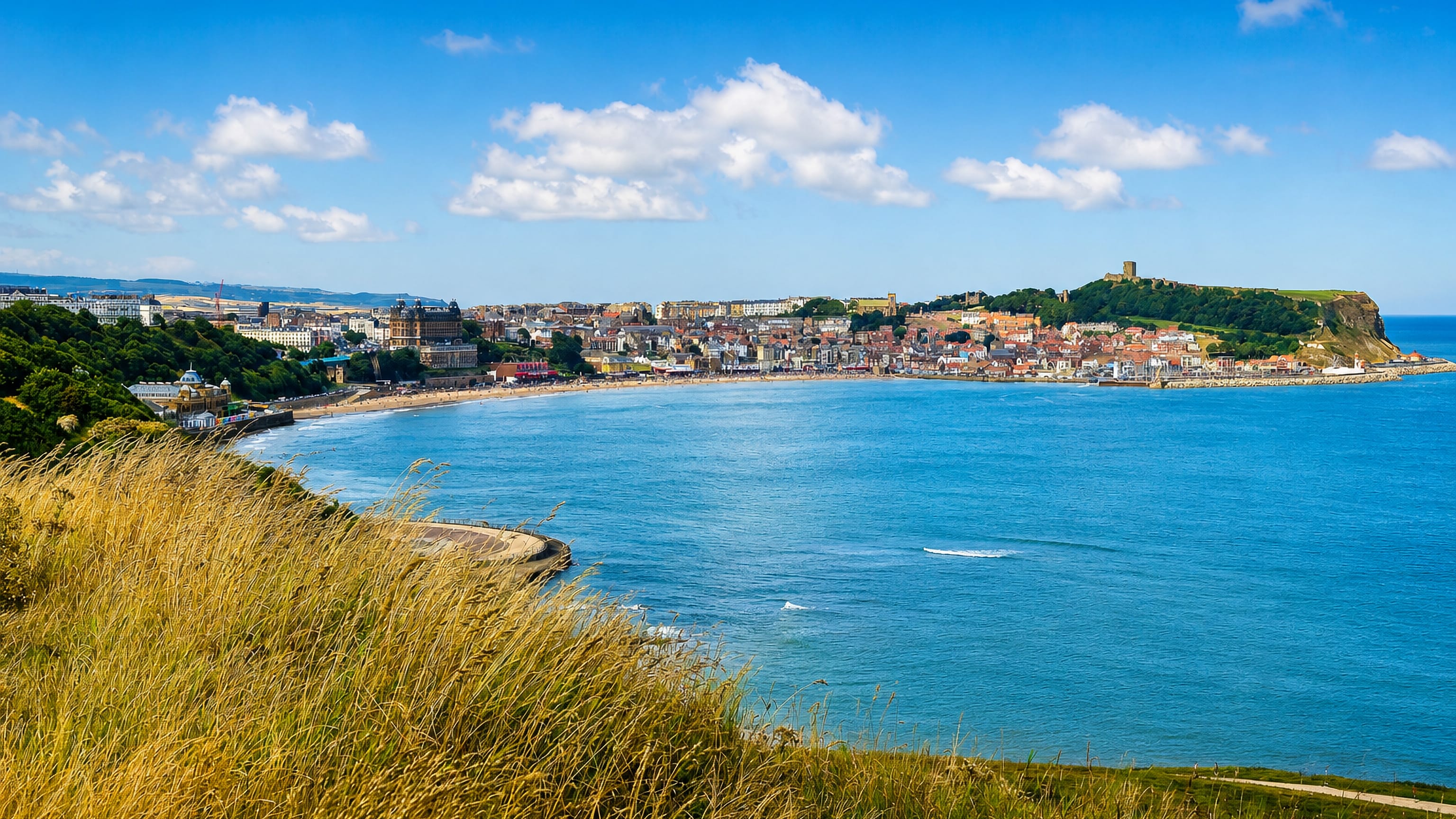 Scarborough's South Bay from the cliffs, with the Grand Hotel, seafront and castle headland above the harbour.
