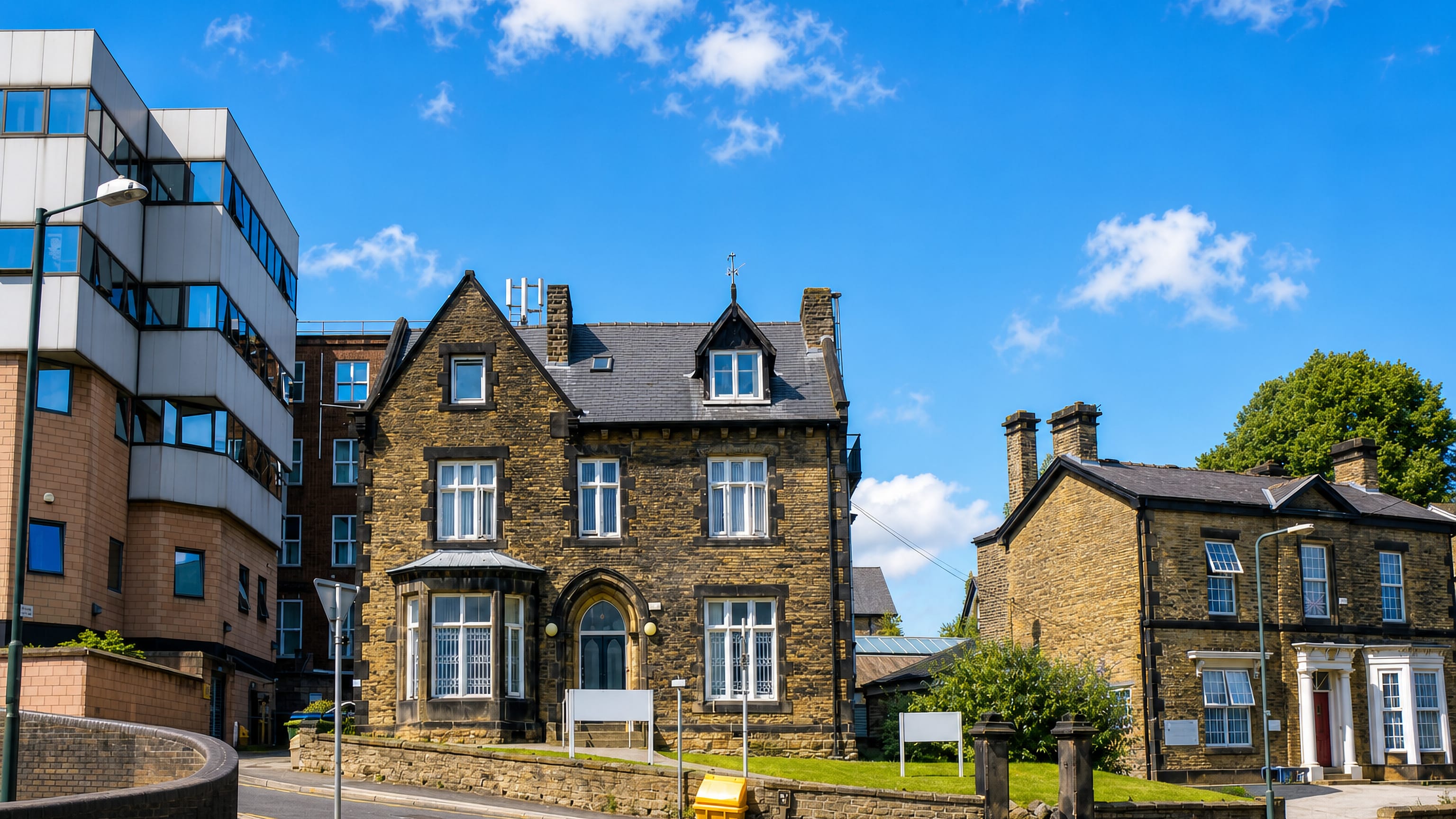 Victorian gritstone villa beside a modern glazed block on a sunlit corner in Broomhill, Sheffield.