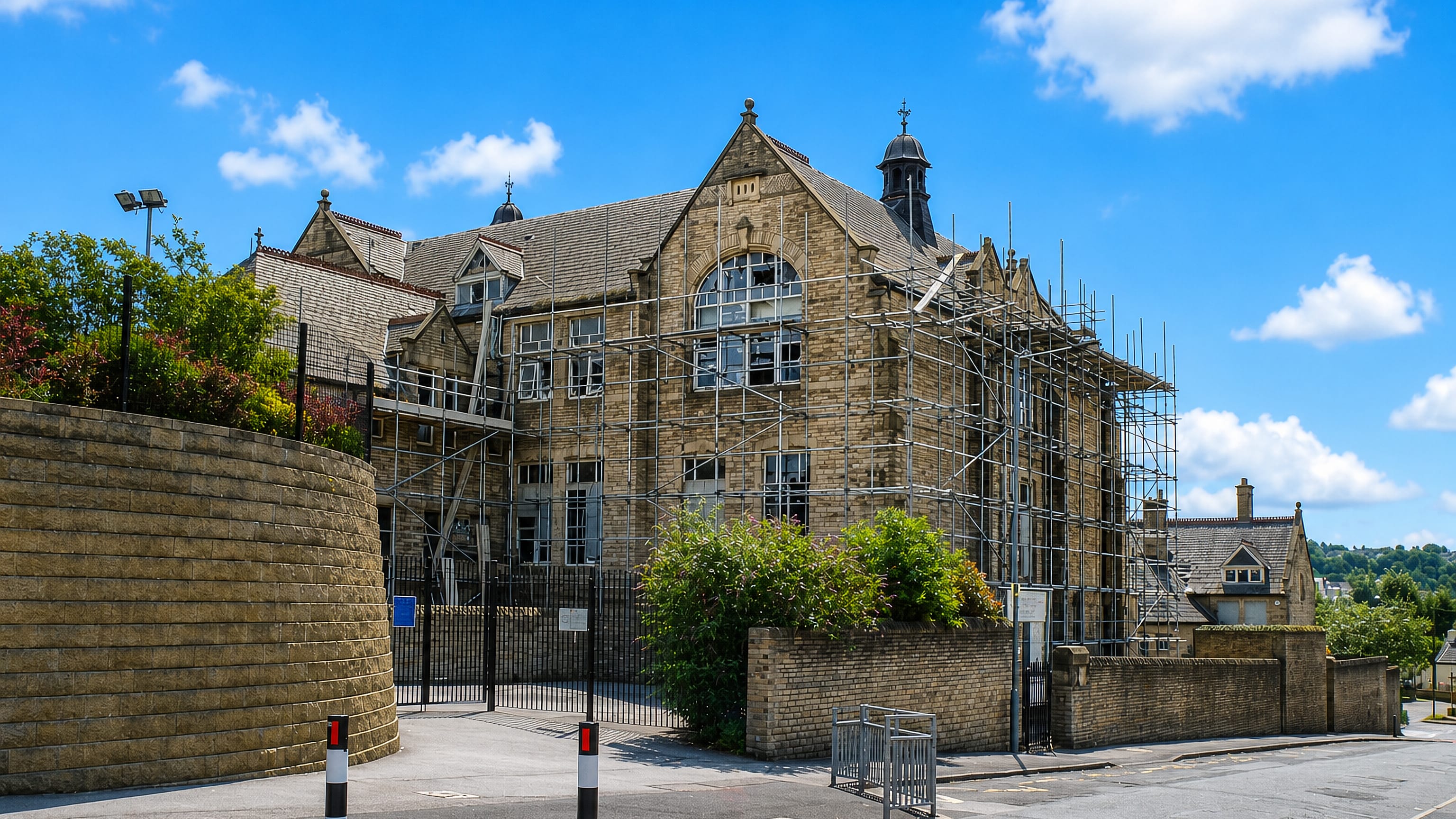 Victorian stone school building under scaffolding on a corner in Heeley, south Sheffield.