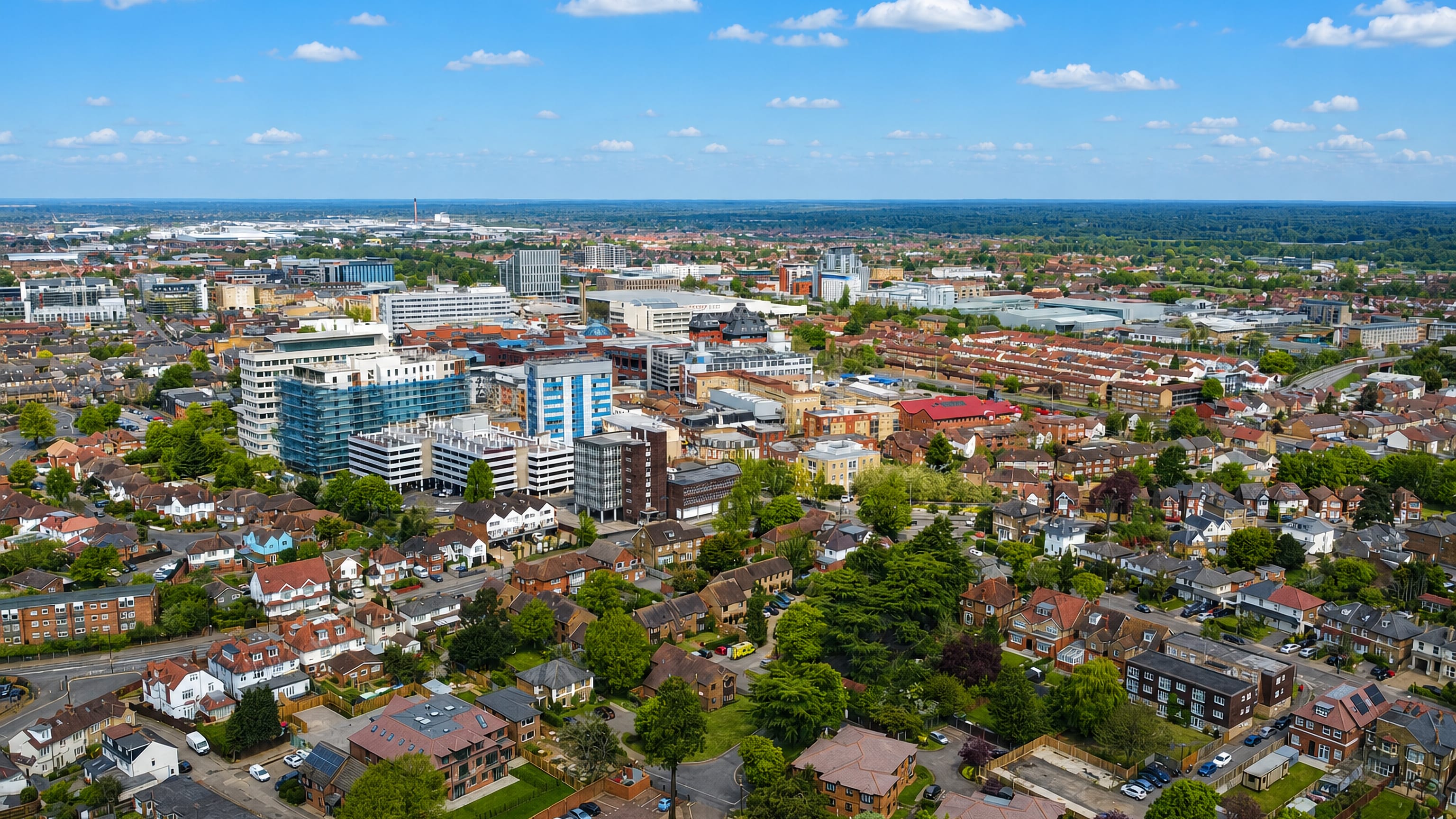 Aerial view over Slough, England, with the town centre's office blocks rising above red-brick suburban streets.