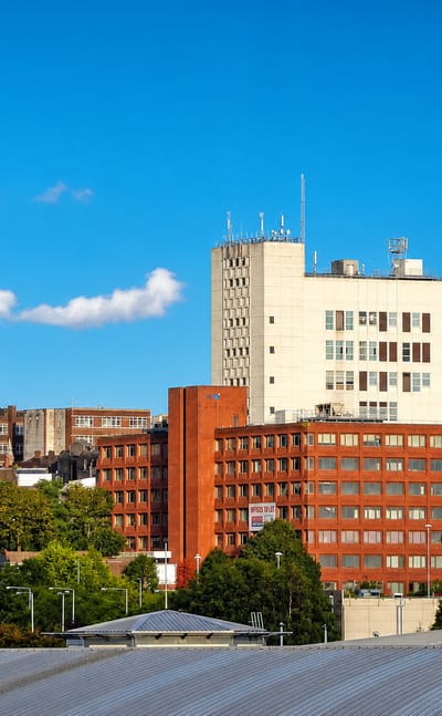 Stoke-on-Trent townscape with the Regent Theatre and red-brick offices under a blue sky