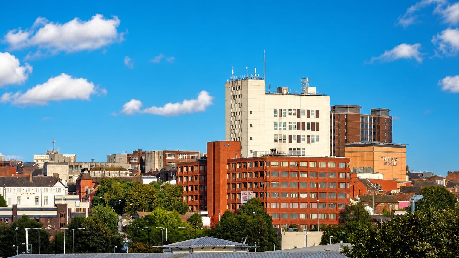 Stoke-on-Trent townscape with the Regent Theatre and red-brick offices under a blue sky