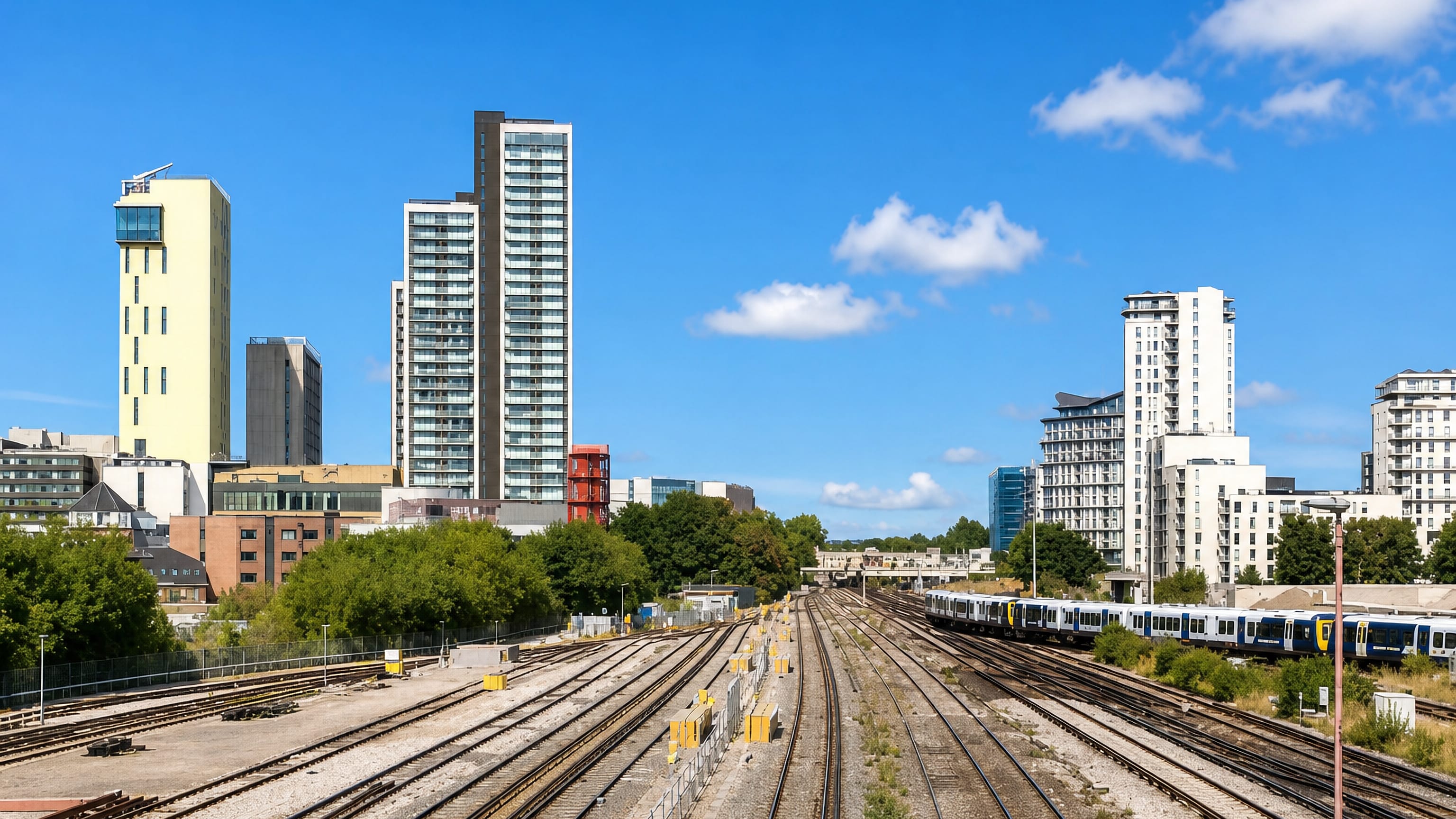 Woking's residential towers and Export House rising beyond the railway junction in Surrey, England.