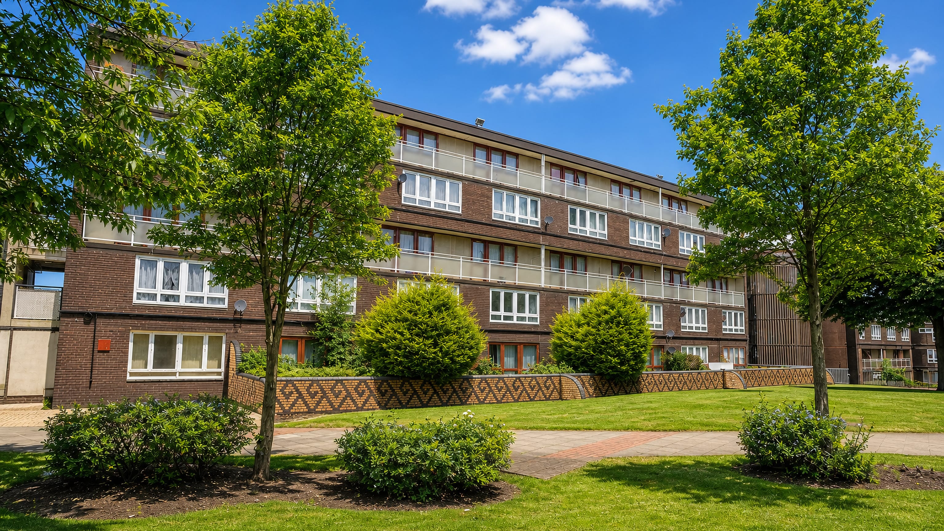 Brick low-rise flats with balconies and lawns in Heath Town, Wolverhampton.