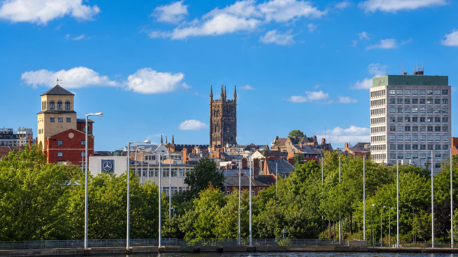 Wolverhampton skyline with St Peter's Church tower and red-brick buildings above a canal