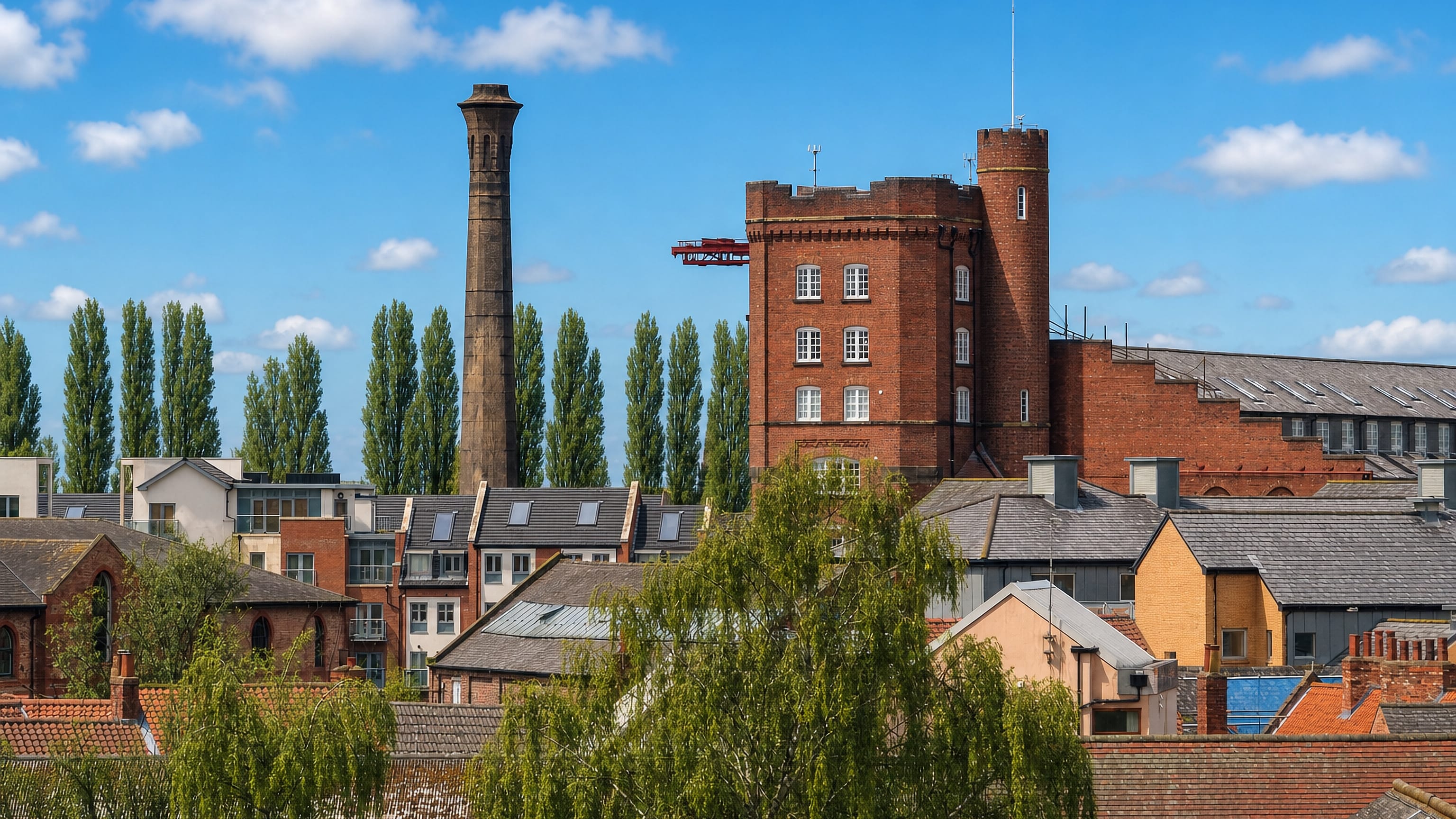Brick industrial tower and tall chimney rising above rooftops in Layerthorpe, York.