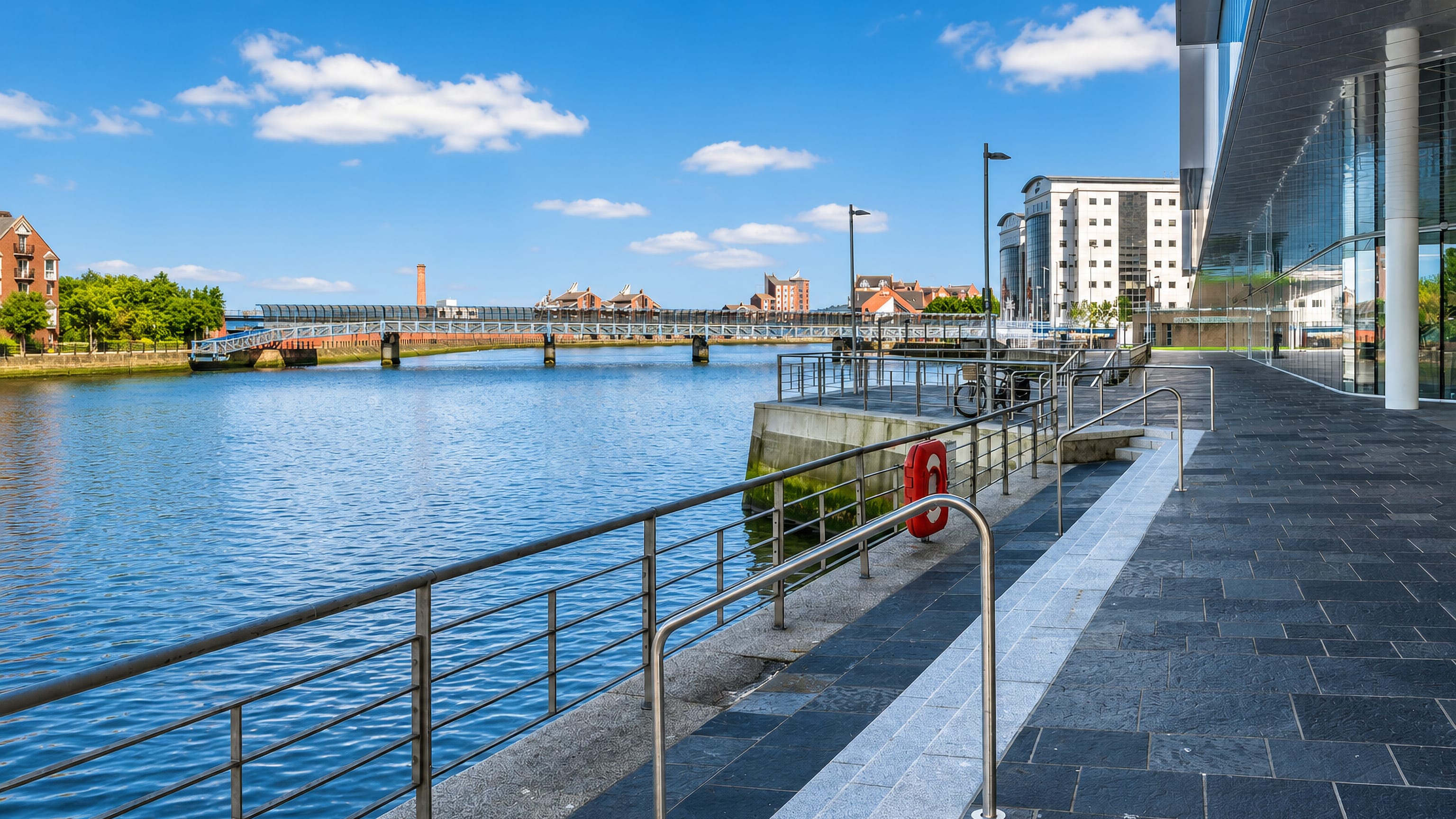 Lagan riverside walkway, weir footbridge and Waterfront Hall in Belfast city centre.