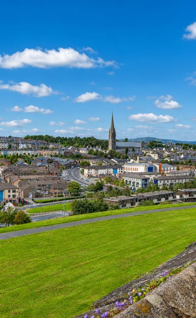 Derry's historic walled city with St Eugene's Cathedral spire and terraced houses seen from the old city walls