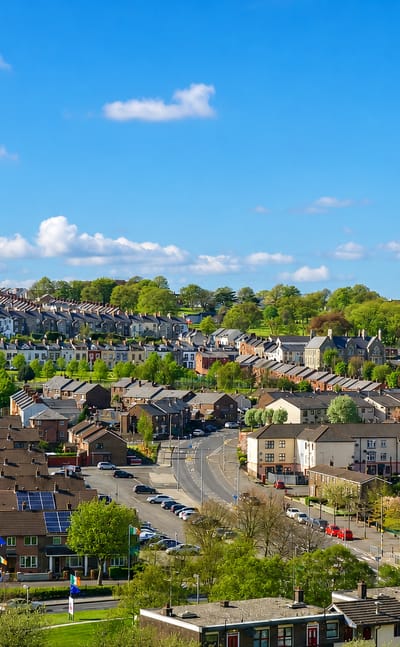 Townscape of Derry with St Eugene's Cathedral spire and terraced houses climbing the hills of Londonderry.
