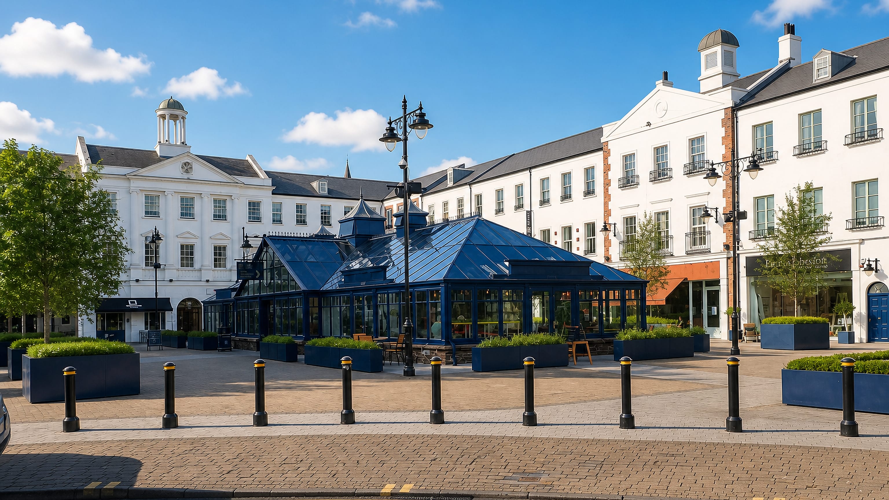 Paved square in Lisburn, Northern Ireland, with a blue glass pavilion cafe framed by white Georgian townhouses.