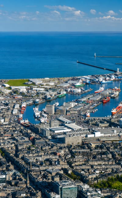 Aerial view of Aberdeen, Scotland, its granite city and busy harbour of supply vessels beside the North Sea