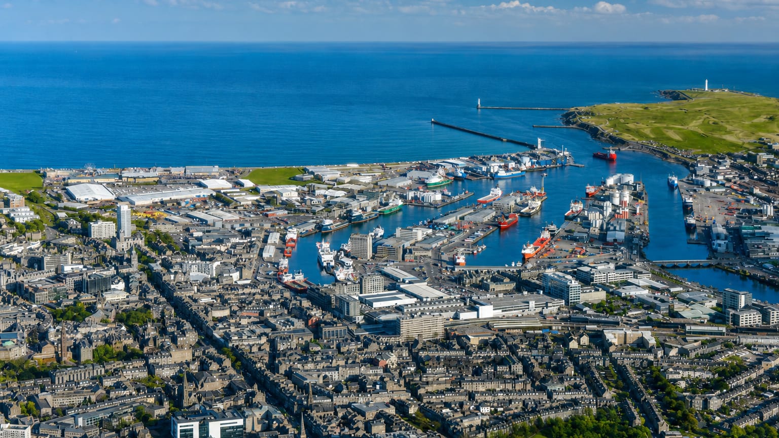 Aerial view of Aberdeen, Scotland, its granite city and busy harbour of supply vessels beside the North Sea
