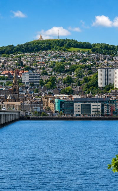 Dundee waterfront on the River Tay, with the Tay Rail Bridge and the Law hill topped by its monument