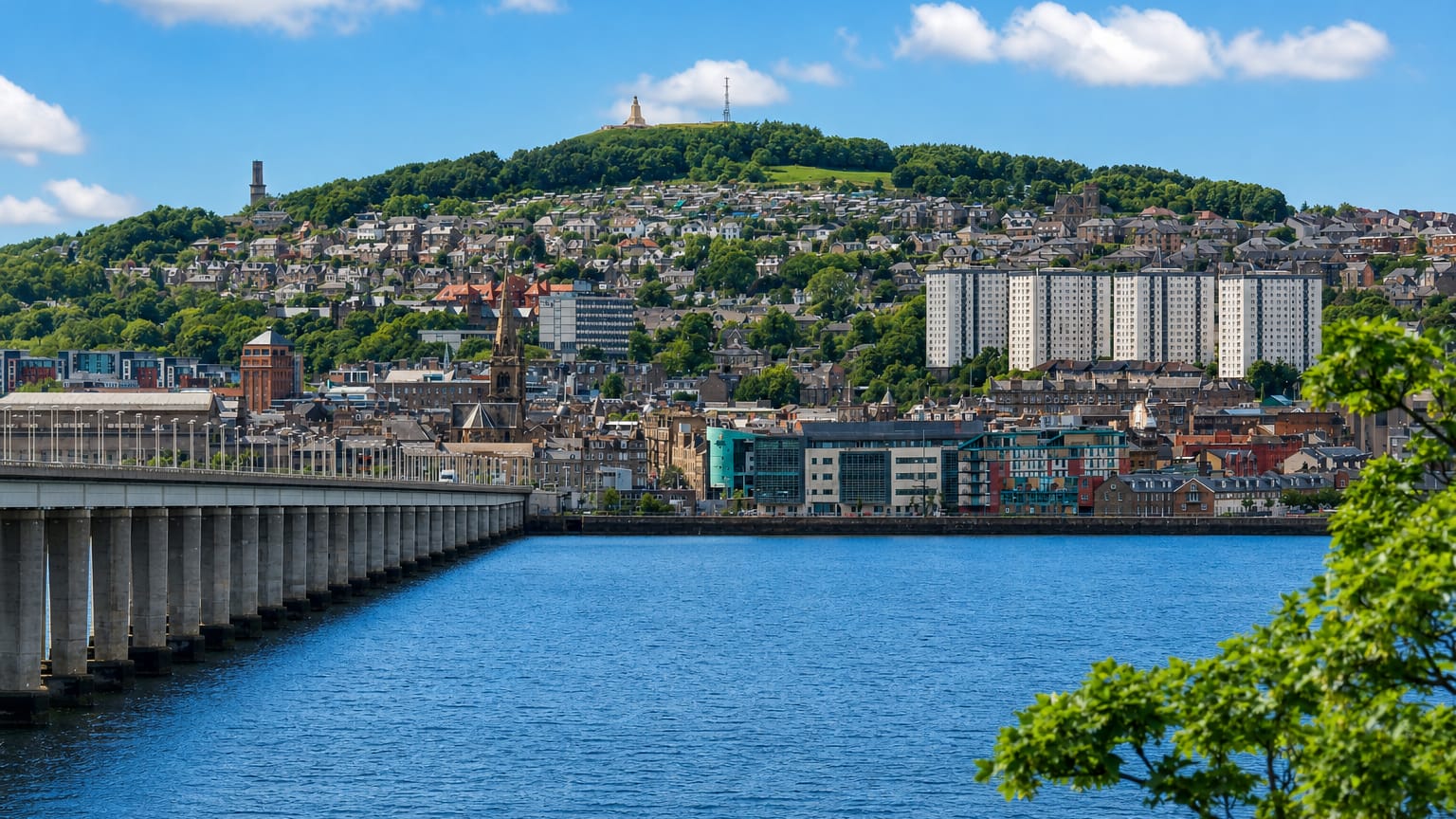Dundee waterfront on the River Tay, with the Tay Rail Bridge and the Law hill topped by its monument