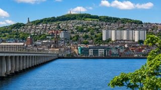 Dundee waterfront on the River Tay, with the Tay Rail Bridge and the Law hill topped by its monument