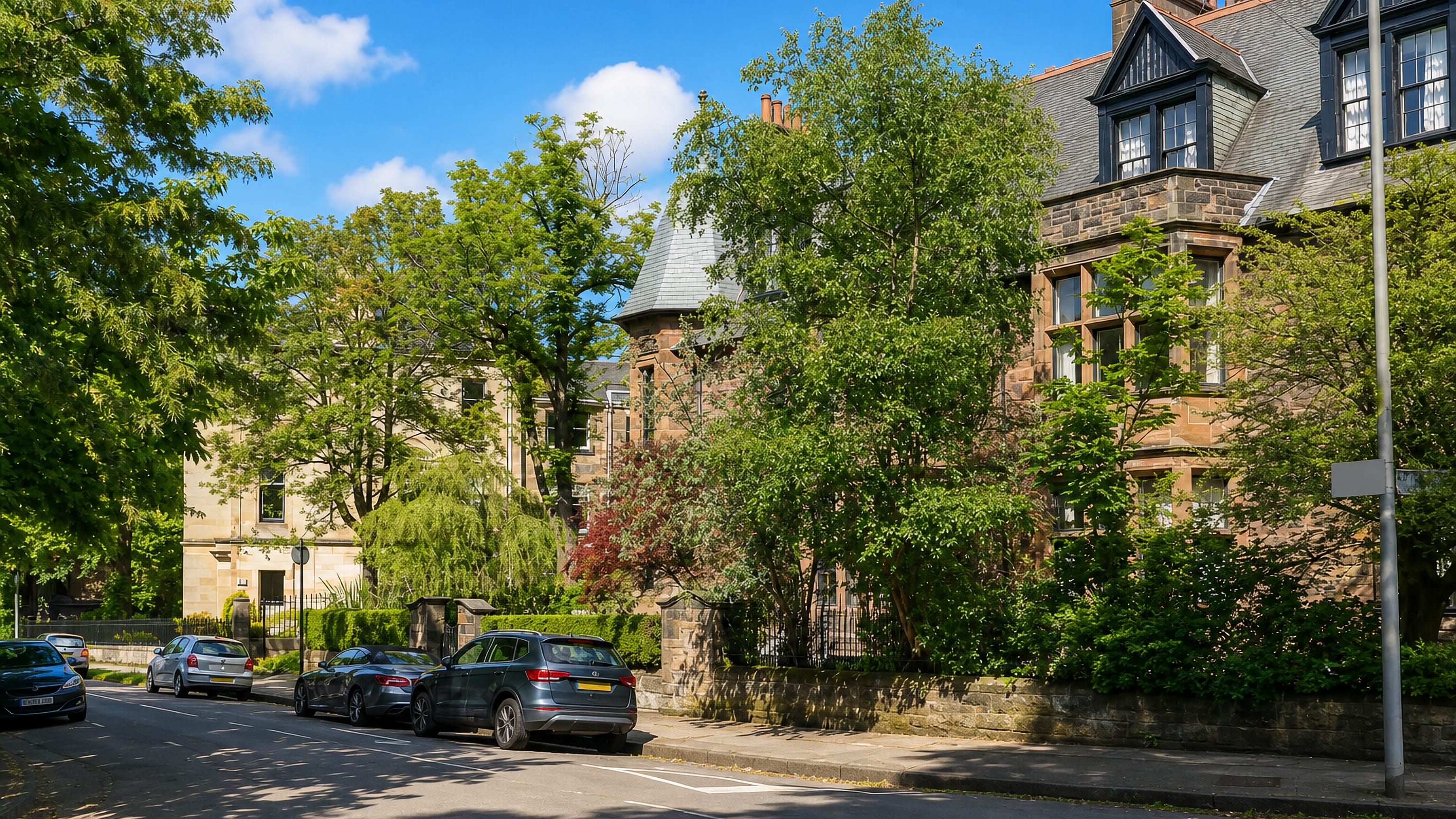 Red and blonde sandstone Victorian villas on a leafy Dowanhill street in Glasgow's West End.