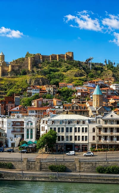 Tbilisi's Old Town below Narikala Fortress with colorful houses, a church and cable car above the river
