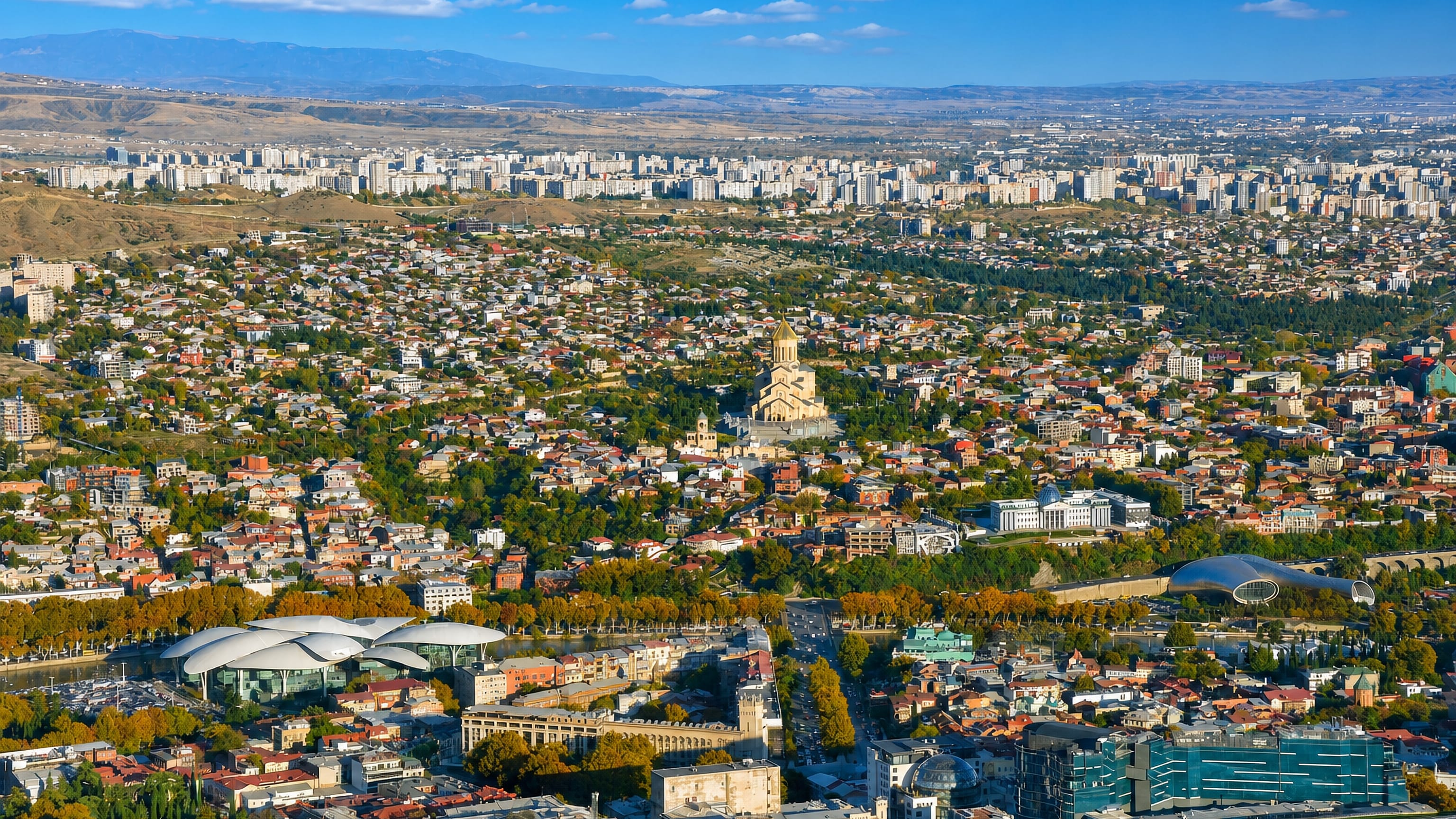 Panorama from Mtatsminda over Tbilisi with Sameba Cathedral, the Presidential Palace and Rike Park.