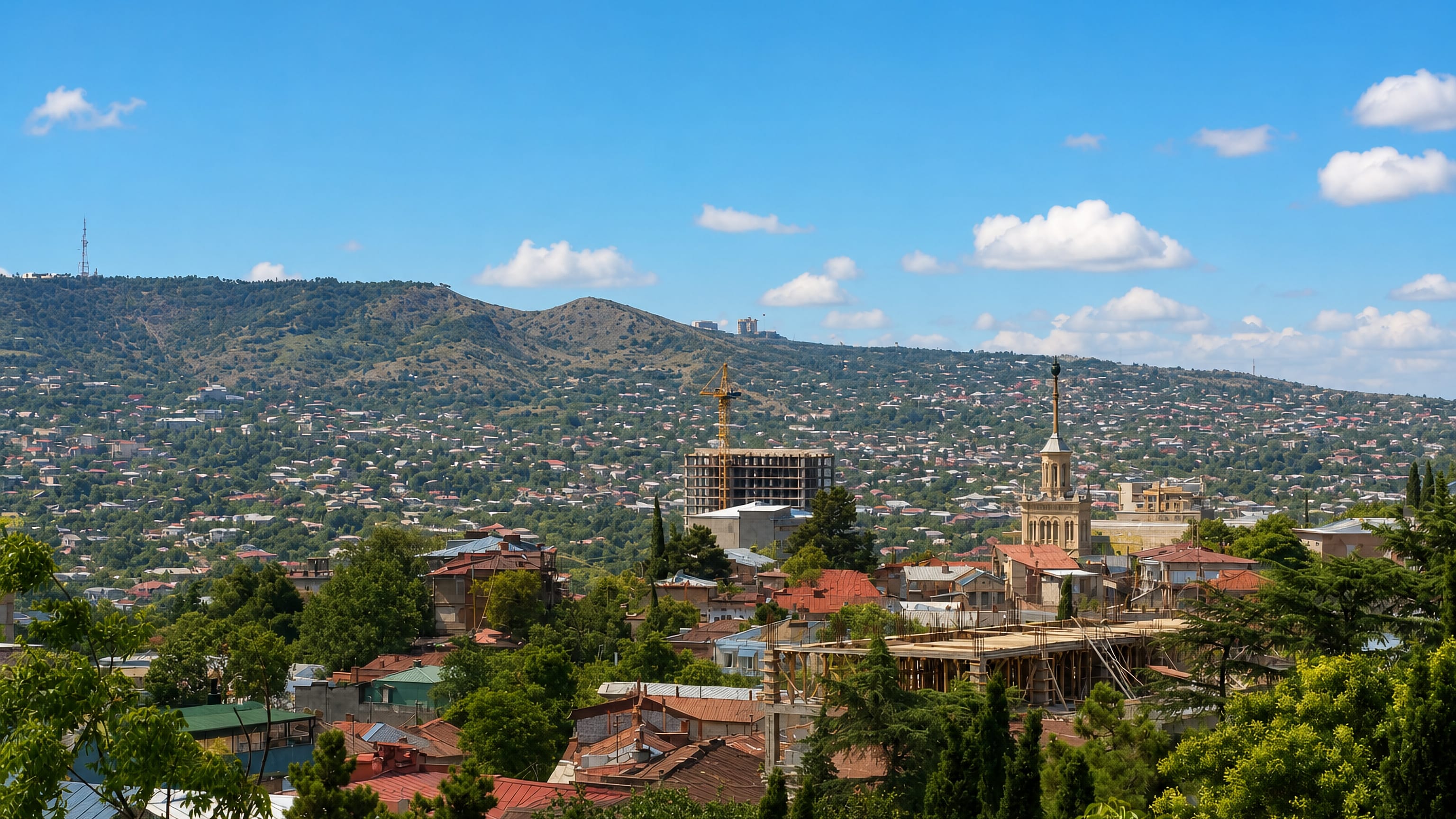 Red-tiled roofs, cypresses and a church spire on the hillsides of the Vera district of Tbilisi.