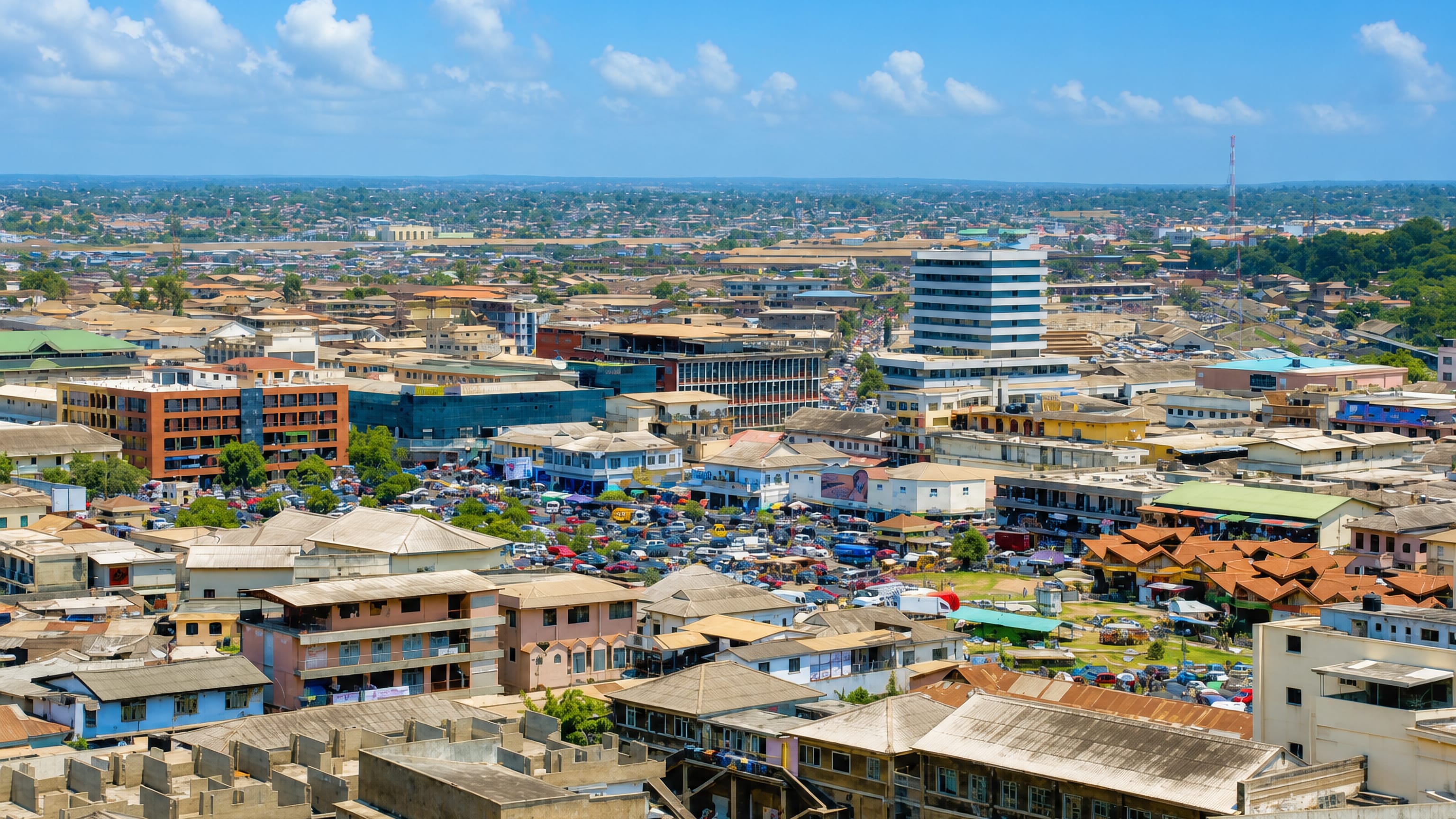 Aerial view of Accra's dense low-rise centre with a busy market and scattered mid-rise buildings