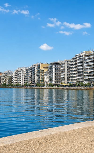 Thessaloniki's seafront promenade curving along the calm Thermaic Gulf beside waterfront apartment blocks