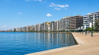 Thessaloniki's seafront promenade curving along the calm Thermaic Gulf beside waterfront apartment blocks