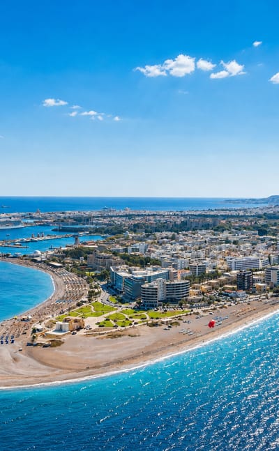 Aerial view of Rhodes town's northern beach spit and harbour with cruise ships on the Aegean.