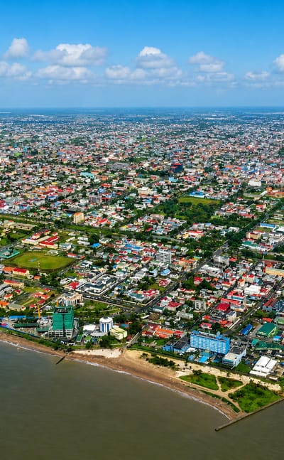 Aerial view of Georgetown, Guyana, spread along the Demerara estuary meeting the Atlantic coast