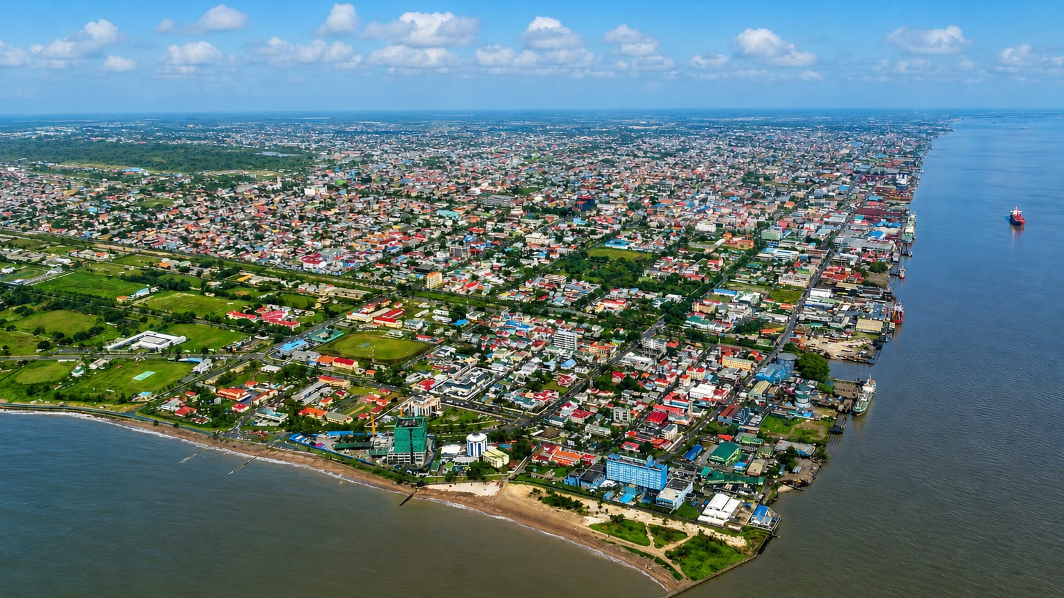 Aerial view of Georgetown, Guyana, spread along the Demerara estuary meeting the Atlantic coast
