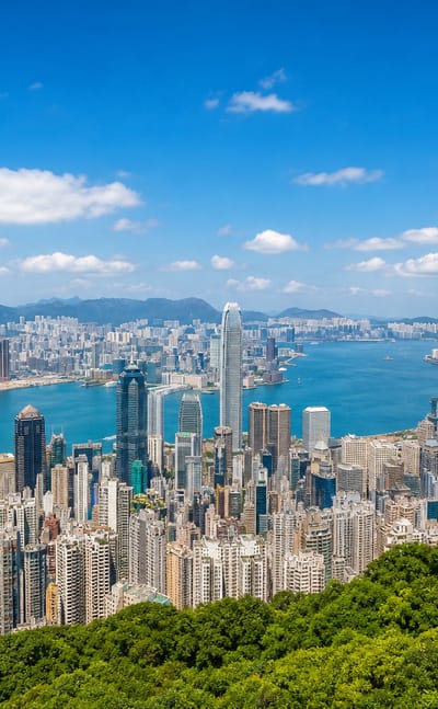 Hong Kong's skyscrapers and Victoria Harbour seen from Victoria Peak toward Kowloon on a clear day.
