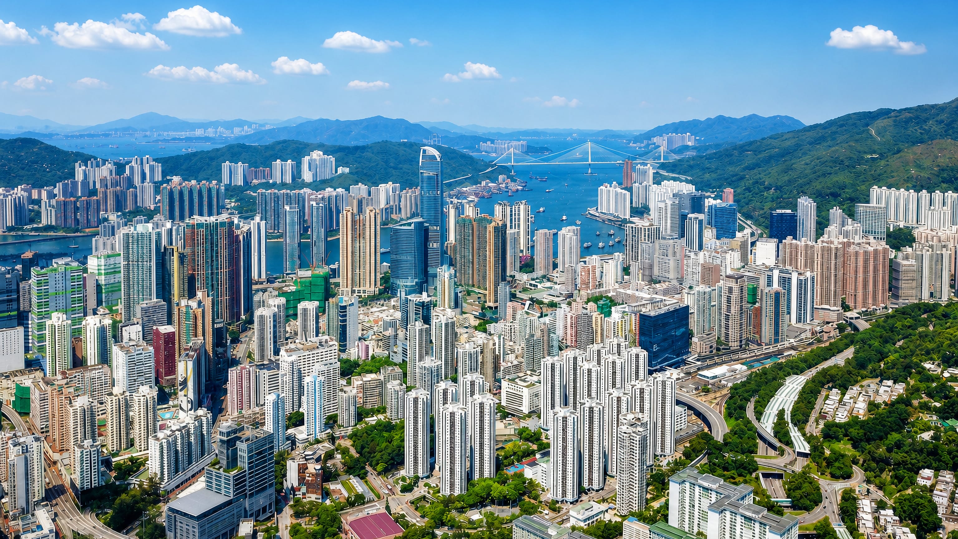 Aerial view of Tsuen Wan, Hong Kong, dense high-rise towers along Rambler Channel with Tsing Ma Bridge beyond