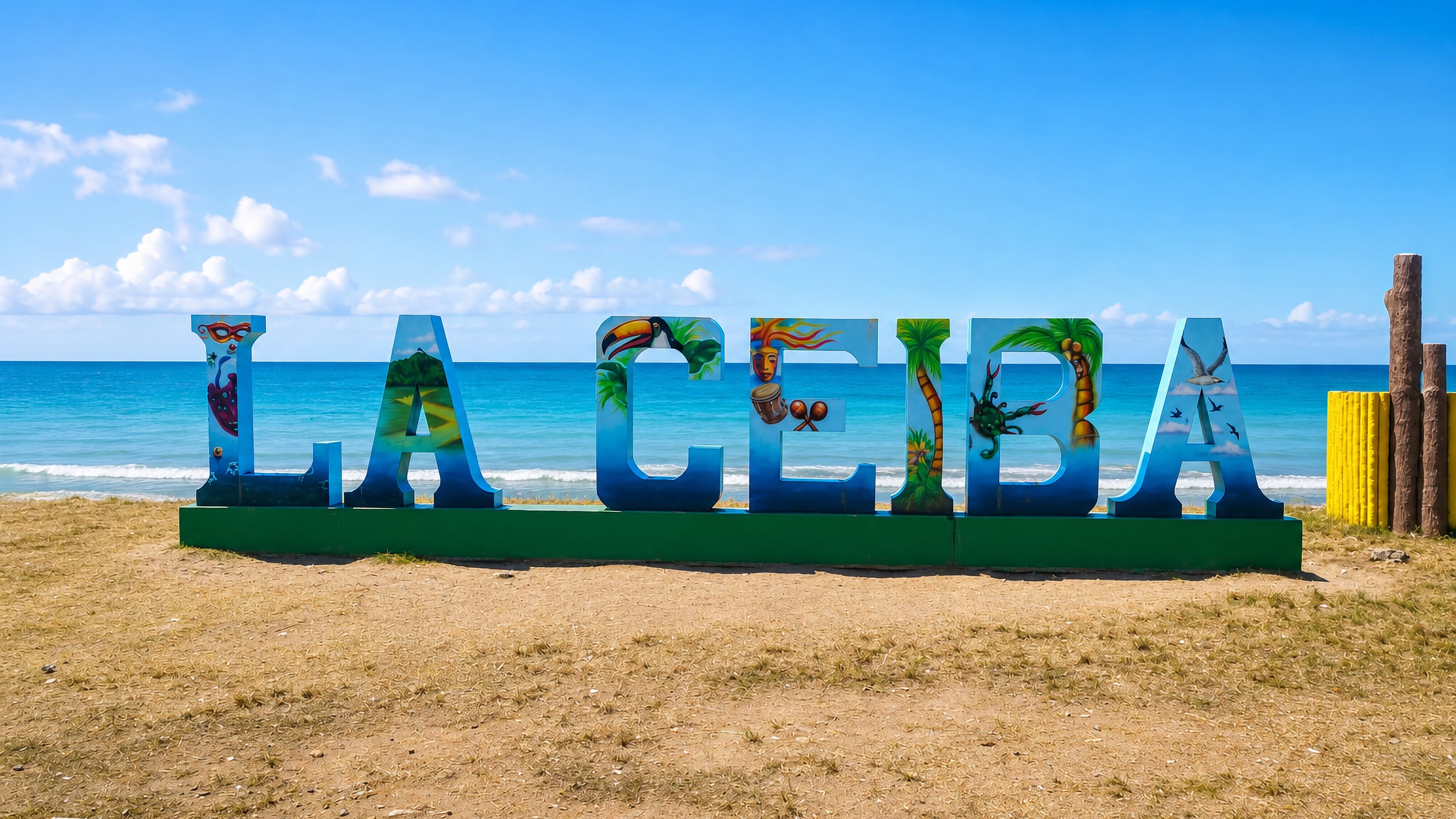 Colorful LA CEIBA letter sign standing on the sandy Caribbean beachfront in La Ceiba, Honduras.