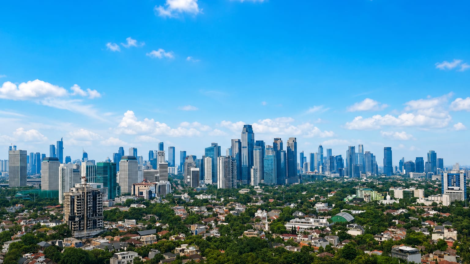 Glass high-rise towers of South Jakarta's business districts rise behind leafy low-rise residential neighborhoods by day.