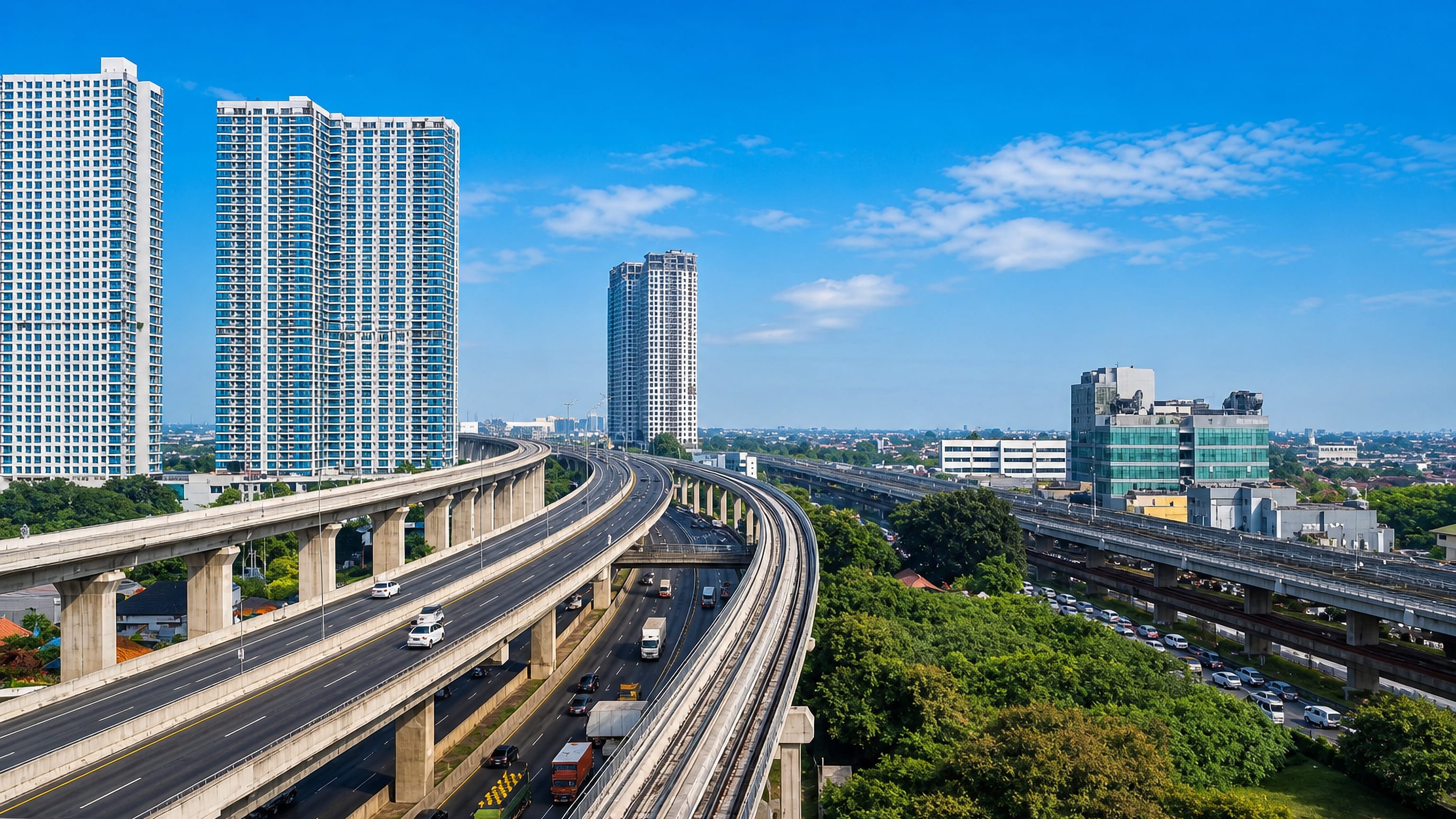 Elevated toll road and LRT viaduct curving past high-rise apartment towers in Bekasi, Indonesia.