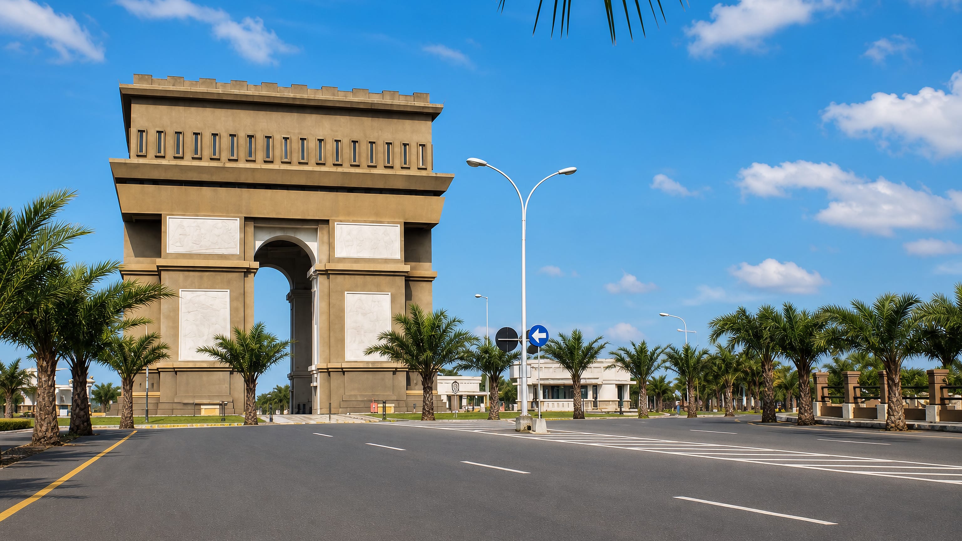 Simpang Lima Gumul arch monument on a palm-lined boulevard in Kediri, Indonesia