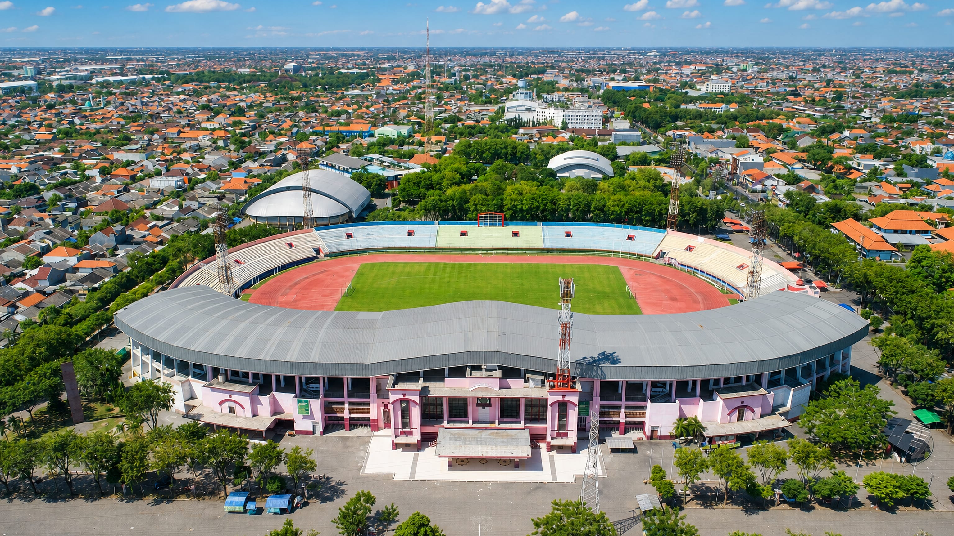 Aerial view of Sidoarjo's stadium in East Java, ringed by the town's dense orange-tiled rooftops.