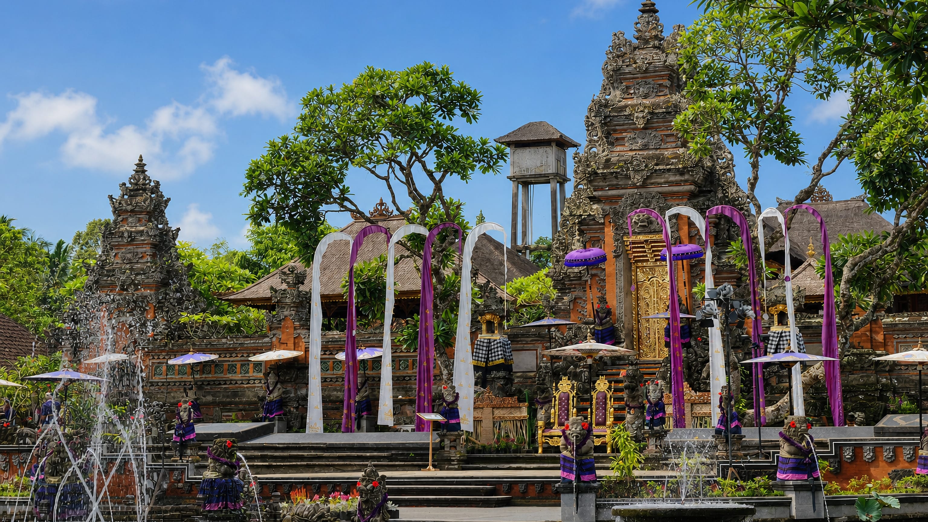 Carved gates, ceremonial umbrellas and penjor banners above the water gardens of Ubud's Saraswati Temple, Bali.