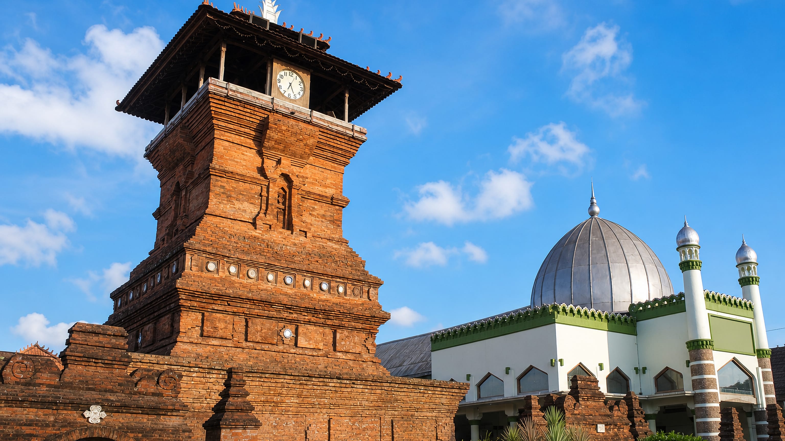 The red-brick Menara Kudus minaret beside the domed Al-Aqsa Mosque in Kudus, Central Java