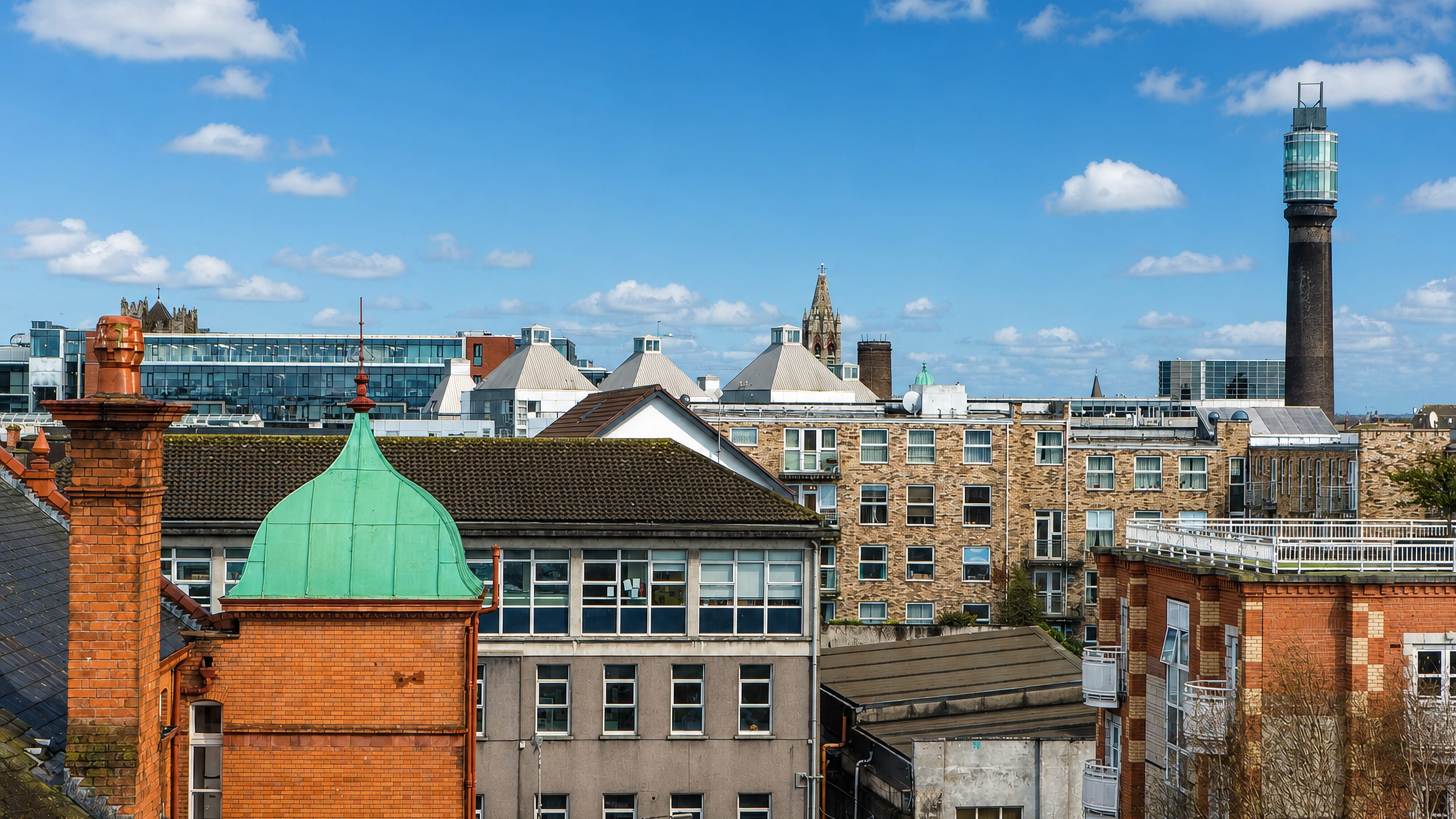 Smithfield rooftops in Dublin beneath the glass-topped former Jameson distillery chimney tower.