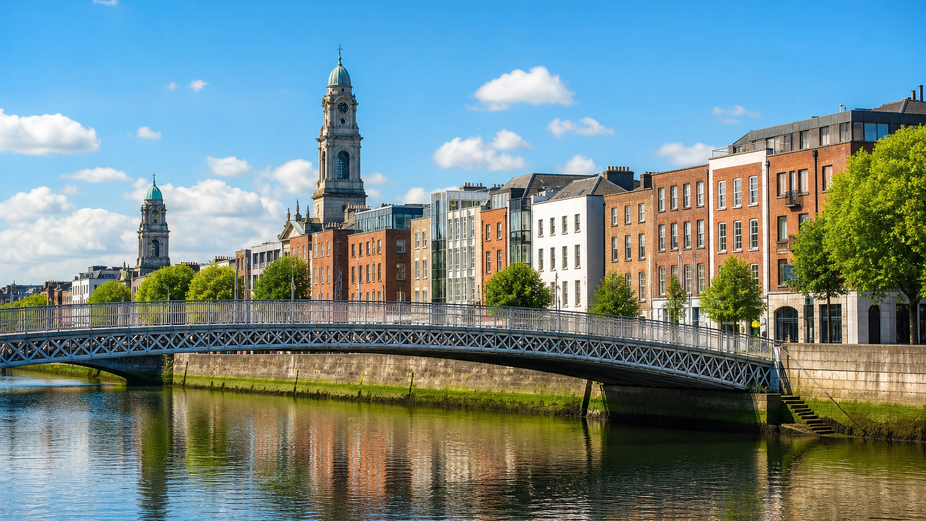 Georgian quayside buildings and a white iron footbridge over the River Liffey by Temple Bar, Dublin.
